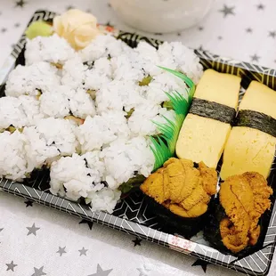 a plate of rice, meat, and vegetables