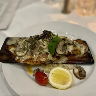 Cedar-roasted red fish topped with crabmeat and mushrooms