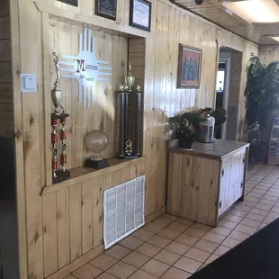 Trophies and Zia symbol.