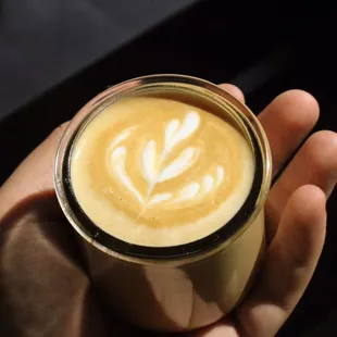 a hand holding a cup of coffee