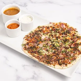 Onion Chilli Uttapam: A soft, savory South Indian pancake topped with spicy chilies and caramelized onions, served with chutney and sambar!