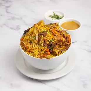 Vegetable Biryani: A fragrant rice dish cooked with fresh vegetables, aromatic spices, and herbs, offering a wholesome and flavorful classic