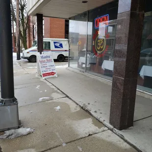 a sign on the sidewalk