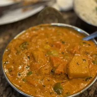 a bowl of curry and a plate of rice