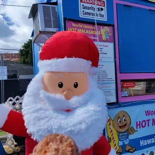 Letting Santa try the Li Hing sugar Malasada