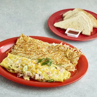 an omelet on a red plate and a sandwich on a red plate