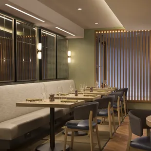 a restaurant with a long table and chairs