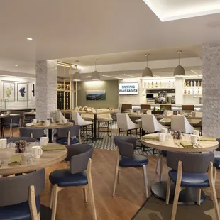 a dining area with tables and chairs