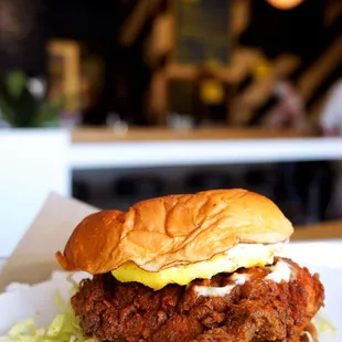 Fried Chicken Sandwich: crispy fried chicken breast on a butter toasted King&apos;s Hawaiian bun with daikon pickles, kewpie mayo, iceberg ($12).