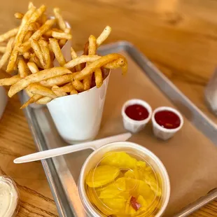 a tray of fries and condiments