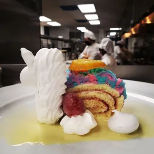 Lemon roulade with raspberry jam and almond unicorn meringue cookie.