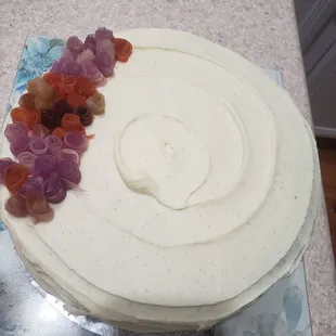 Carrot cake with a vanilla bean icing. Carrot rosettes on top.