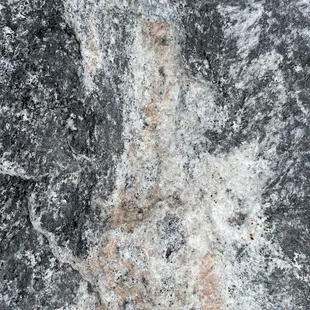 Closeup of a black granite boulder.