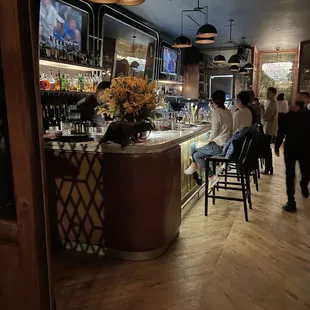 a bar with people sitting at it