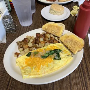 Veggie omelet with home fries. Biscuit. Eggs &amp; bacon.