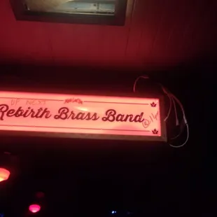 a neon sign above the bar