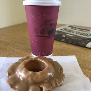 Maple old fashioned donut and a cup of coffee