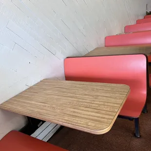 a row of pink booths