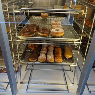 a variety of donuts in a display case