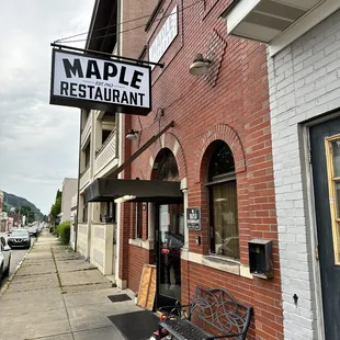 a bench on the sidewalk in front of the building