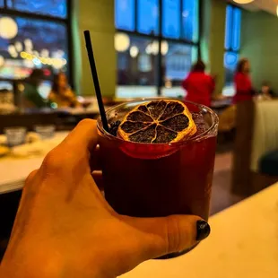 a person holding a drink