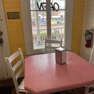 a pink table and chairs