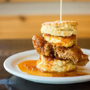 The Squawking Goat: Fried chicken, breaded and toasted goat cheese, topped with house made sweet pepper jelly, all on a biscuit sandwich.