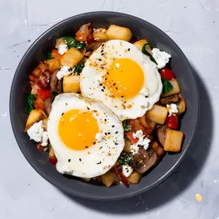 Hash Bowl: Crispy potatoes, bacon, peppers, onions, mushrooms, goat cheese, two eggs your way, topped with everything bagel seasoning.