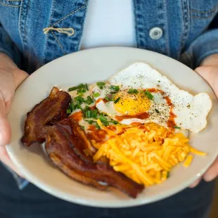 Bluegrass Grits Bowl: Creamy grits, bacon, cheddar, green onion, hot sauce, an egg your way.