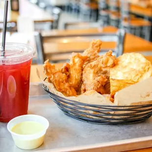 a basket of fried chicken wings and a drink