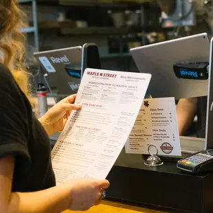 a customer handing a menu to a customer