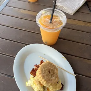 Bacon, egg and cheese biscuit sandwich and orange juice