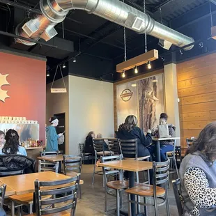 people sitting at tables in a restaurant