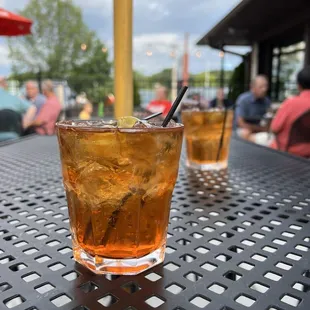 two glasses of iced tea on a table