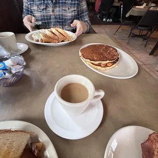 Coffee, pancakes, chicken fried steak, eggs and toast.
