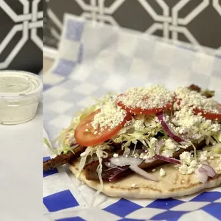 GYRO:
Beef &amp; lamb meat topped with lettuce, tomatoes, onions, and a side of homemade tzatziki sauce