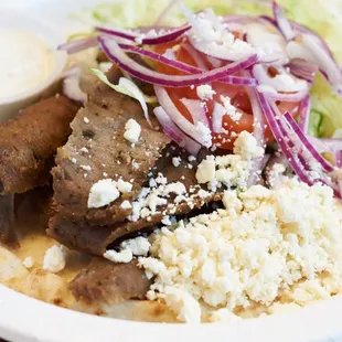 Gyro- Lamb and beef, topped with lettuce, tomato, onions, and feta cheese. Comes with side of homemade tzatziki sauce