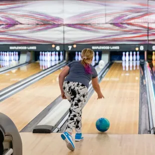 a woman playing a game of bowling