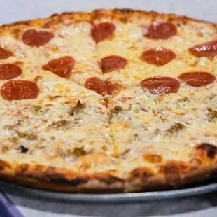 a pepperoni pizza on a pan