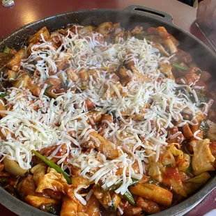 a pan of food with cheese on top