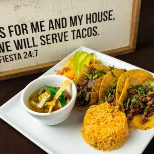 a plate of tacos and a bowl of salsa