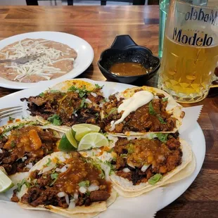 5 tacos for $3 each and a 23 ounce beer on tap for $6. $5 side of beans. Great prices and flavor. Chorizo, al pastor and carnitas