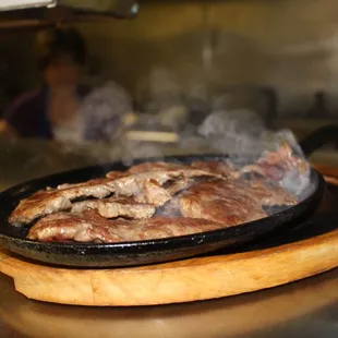 An order of carne asada served straight off the grill, cooked to your request!