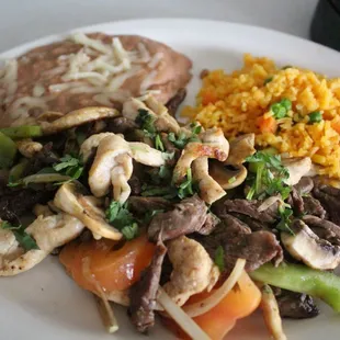 A delicious plate of fajitas served with rice and beans!