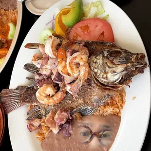 a plate of fish and a bowl of sauce