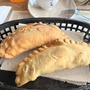 Empanadas -- one cheese and the other guava and cheese. They may not look like much but *chef&apos;s kiss*