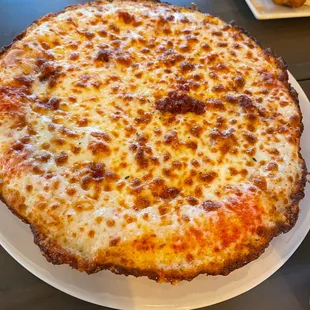 a cheese pizza on a white plate