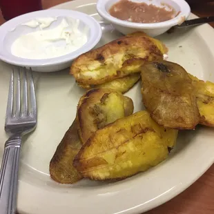 Plantains with sour cream and refried beans.
