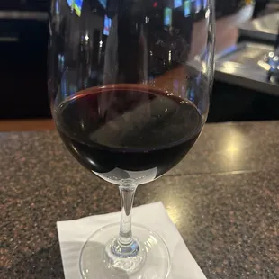 a glass of wine on a napkin
