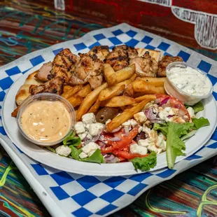 Our juicy chicken souvlaki platter served with pitas, french fries, and salad.
